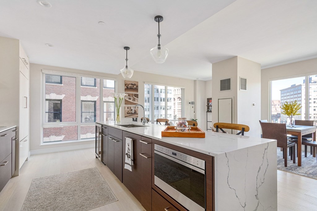 110 Broad Street, Unit 501 Boston, MA 02110 - Photo 20 of 41 a open kitchen with stainless steel appliances granite countertop a stove a sink and a refrigerator