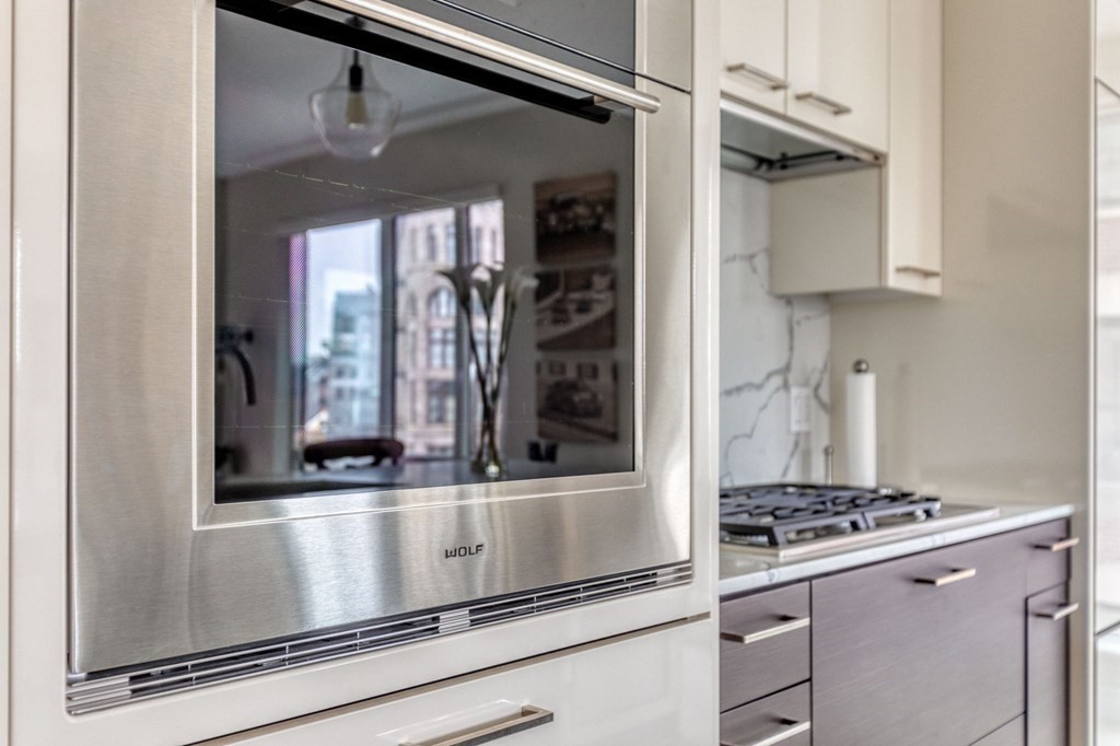 110 Broad Street, Unit 501 Boston, MA 02110 - Photo 27 of 41 a kitchen with stainless steel appliances granite countertop a refrigerator and a stove