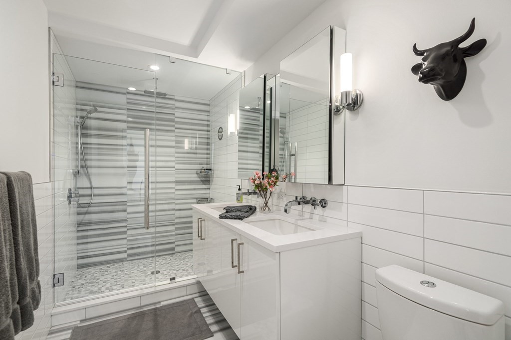 110 Broad Street, Unit 501 Boston, MA 02110 - Photo 4 of 41 a bathroom with a sink a toilet and shower