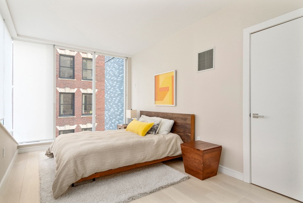 110 Broad Street, Unit 501 Boston, MA 02110 - Photo 6 of 41 a bedroom with a bed and window