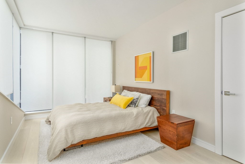 110 Broad Street, Unit 501 Boston, MA 02110 - Photo 7 of 41 a bedroom with a bed and painting on the wall