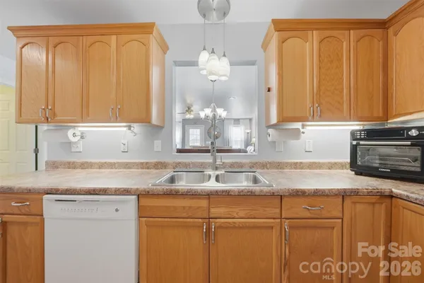 a kitchen with granite countertop cabinets and window