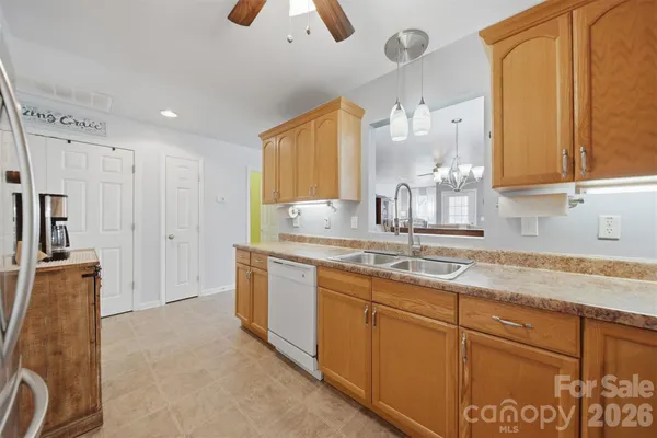 a kitchen with stainless steel appliances granite countertop a sink and a granite counter tops