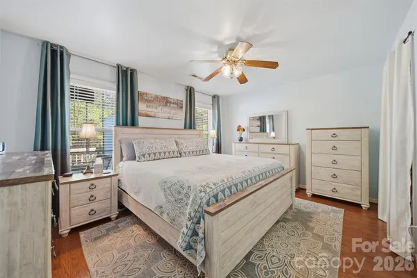 a spacious bedroom with a bed and a dresser