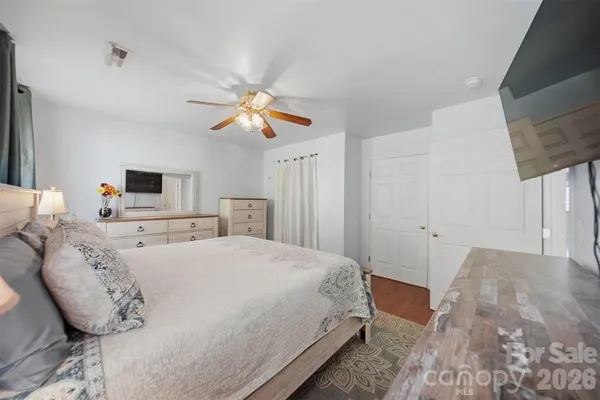 a spacious bedroom with a bed and a chandelier