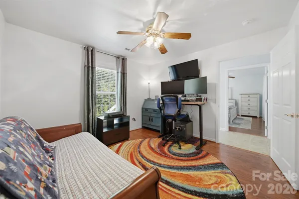 a bedroom with bed and a chandelier