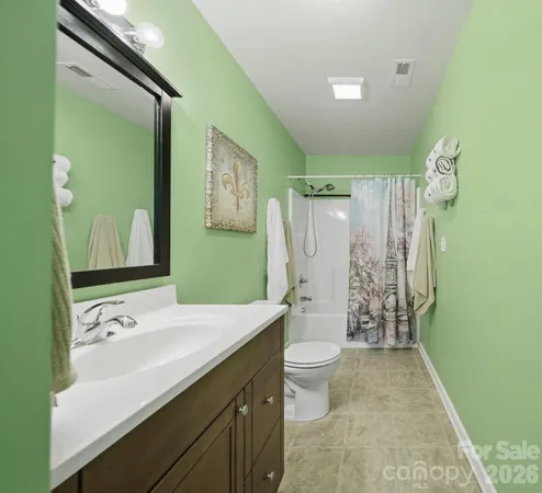 a bathroom with a double vanity sink toilet and shower