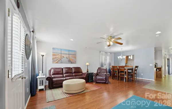a living room with furniture and wooden floor