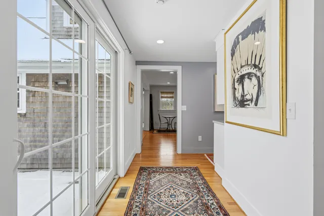 a dining room with furniture and wooden floor