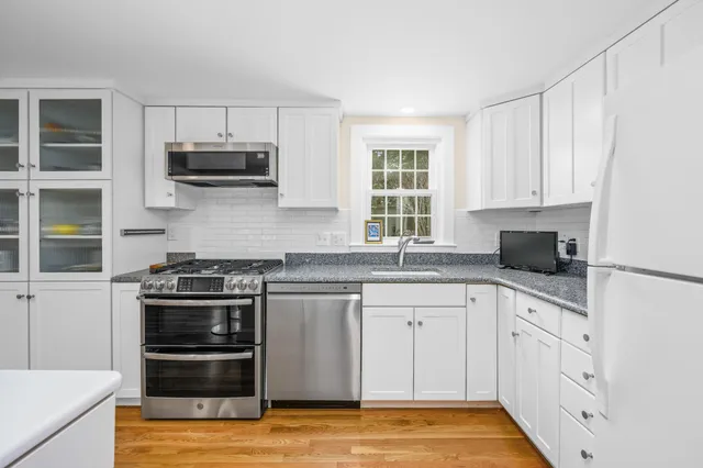 a kitchen with cabinets and stainless steel appliances