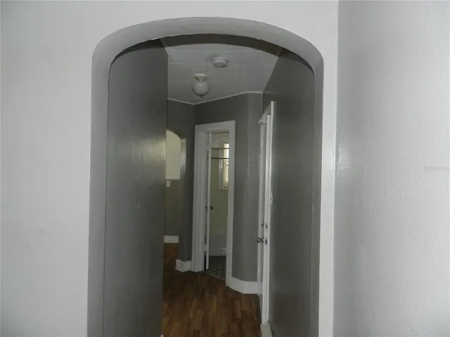 a view of a hallway with wooden floor