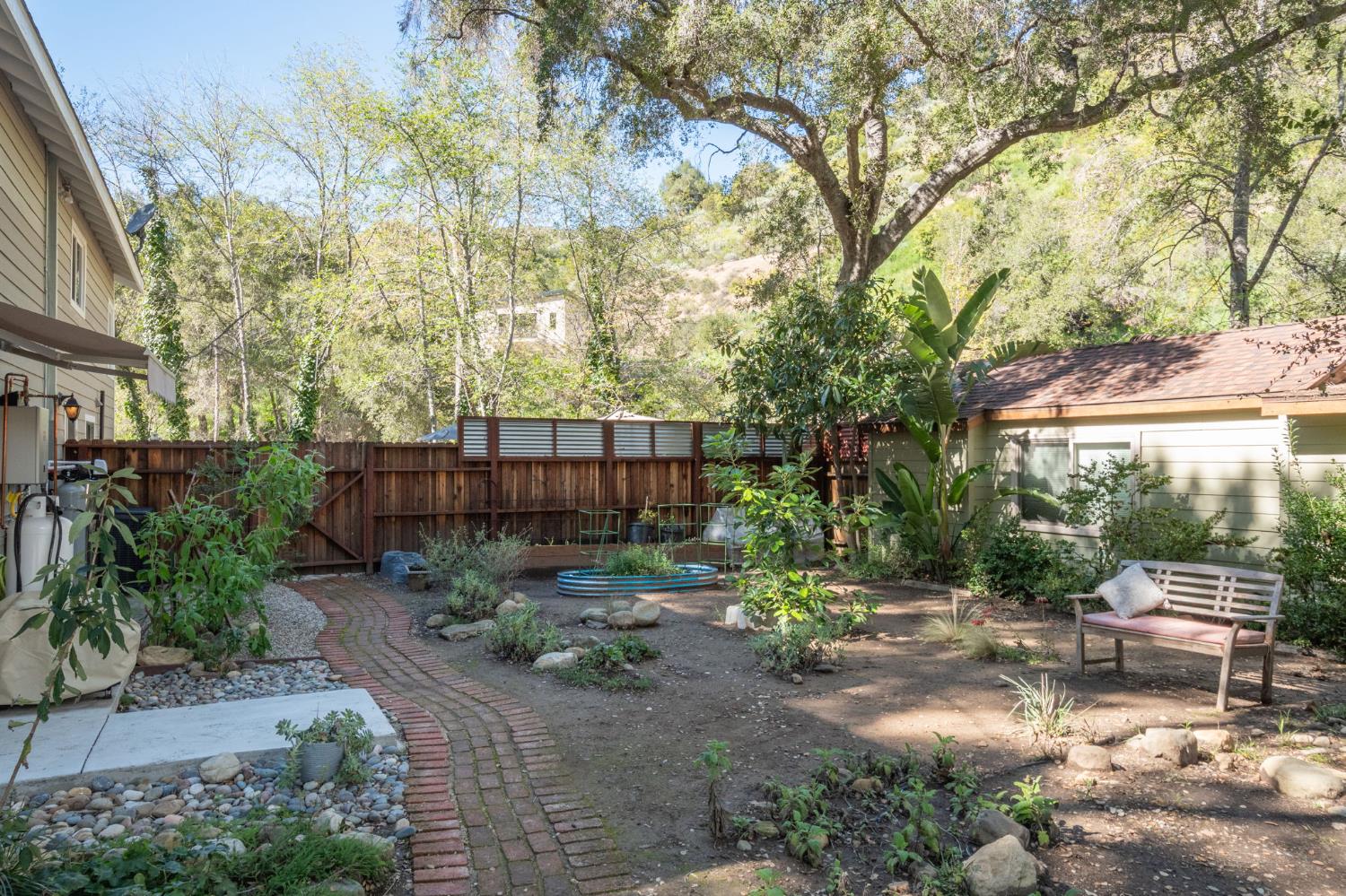 15663 Ojai Road Santa Paula, CA 93060 - Photo 32 of 47 a backyard of a house with lots of green space and fountain
