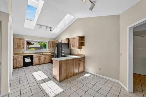 a kitchen with stainless steel appliances a sink and a counter top space