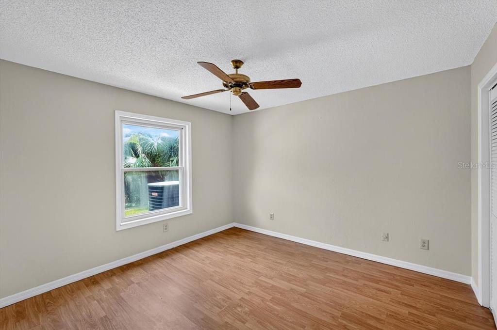 16 Fox Hollow Drive Ormond Beach, FL 32174 - Photo 15 of 38 an empty room with wooden floor and ceiling fan