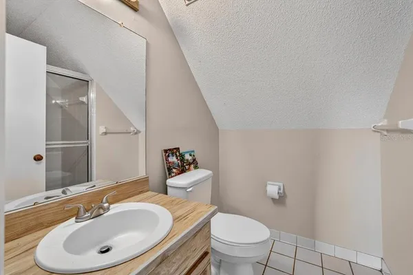 a bathroom with a sink toilet and mirror