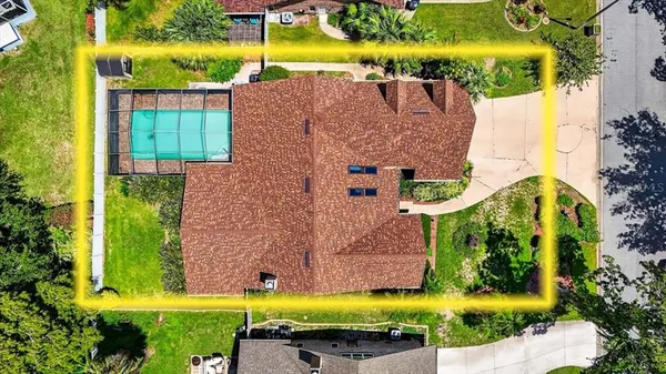 an aerial view of a house with a swimming pool