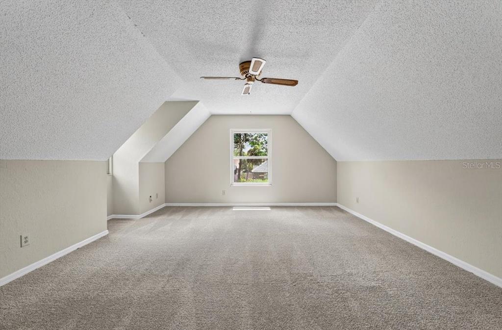 16 Fox Hollow Drive Ormond Beach, FL 32174 - Photo 21 of 38 an empty room with windows and ceiling fan
