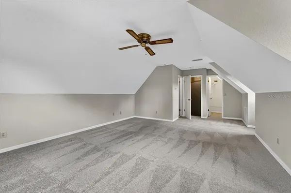 a view of a livingroom with a ceiling fan and window