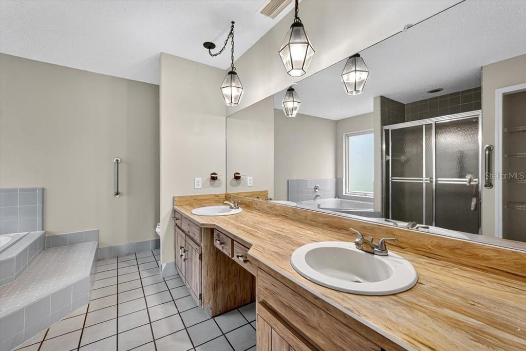 16 Fox Hollow Drive Ormond Beach, FL 32174 - Photo 23 of 38 a bathroom with a granite countertop sink a toilet and a mirror