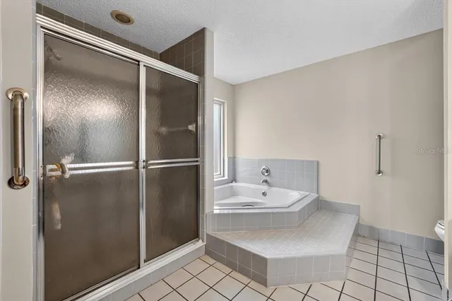 a bathroom with a sink mirror and shower
