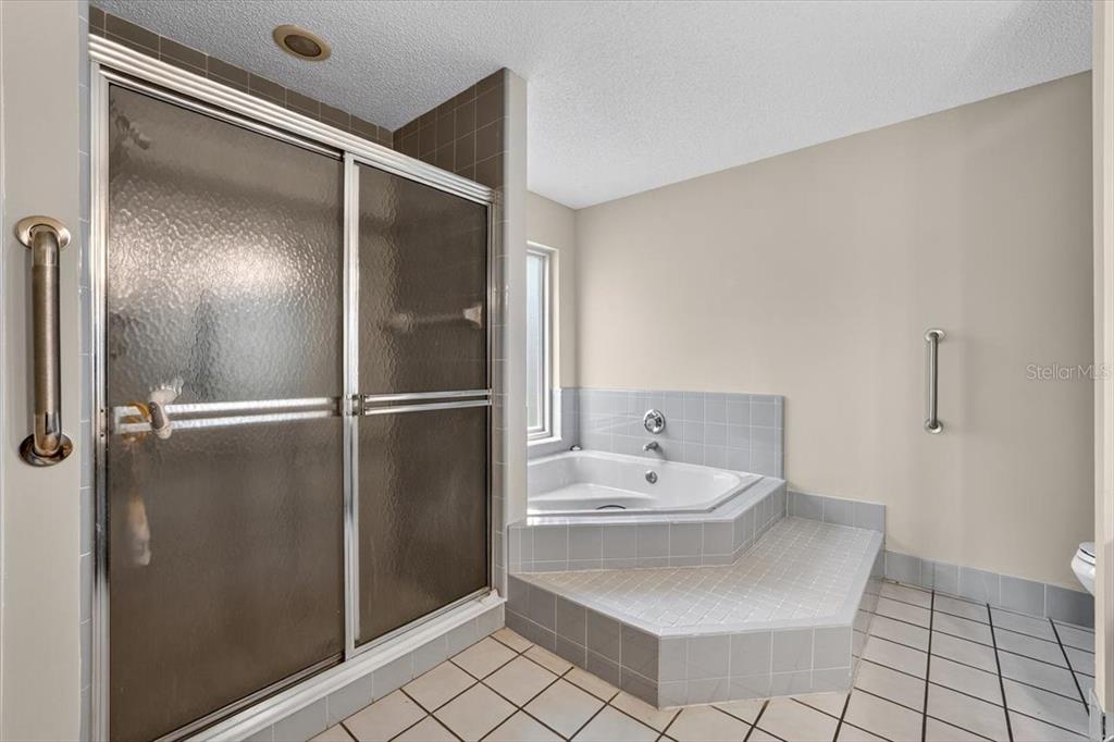 16 Fox Hollow Drive Ormond Beach, FL 32174 - Photo 24 of 38 a bathroom with a sink mirror and shower