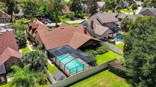 an aerial view of a house with a garden and swimming pool