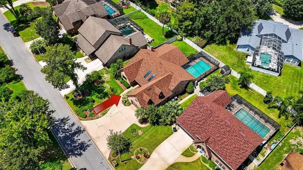 an aerial view of a house with a yard