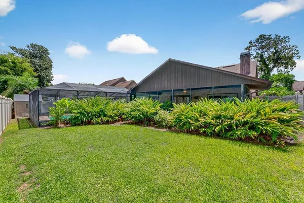 a view of a house with a yard and a garden