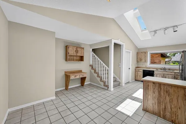 a view of a livingroom with furniture and staircase