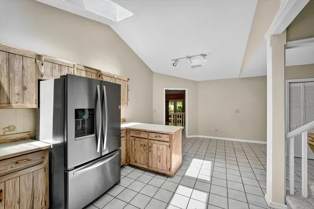 a kitchen with stainless steel appliances a refrigerator and a stove
