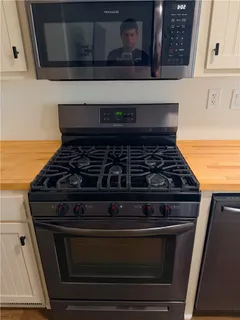 a stove top oven sitting inside of a kitchen