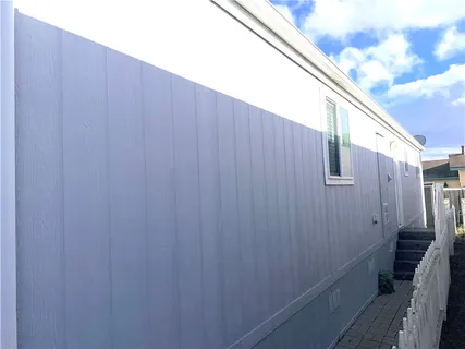 a view of a house with a wooden wall