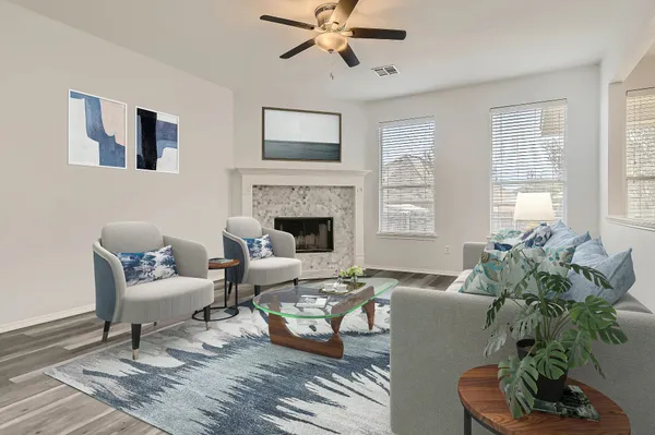 a living room with furniture a fireplace and a window