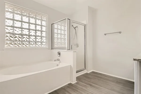 a bathroom with a bathtub and a shower