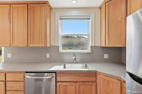 a kitchen with a sink cabinets and window