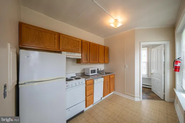 a kitchen with stainless steel appliances granite countertop a refrigerator a stove a sink and a cabinets