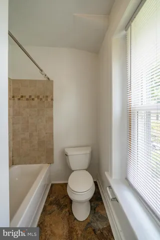 a bathroom with a toilet and a bathtub