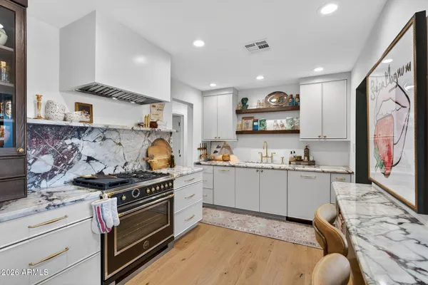 a kitchen with stainless steel appliances granite countertop a stove and a sink