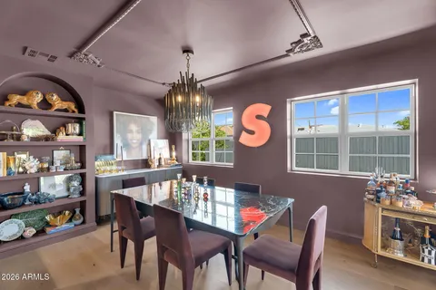 a view of a dining room with furniture a chandelier and wooden floor