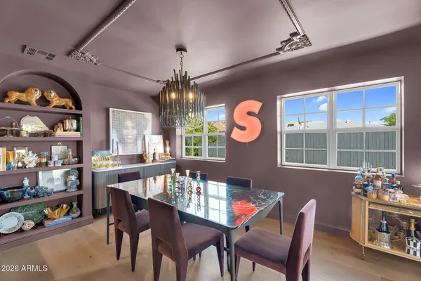 a view of a dining room with furniture a chandelier and wooden floor