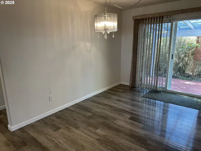 en empty room with wooden floor