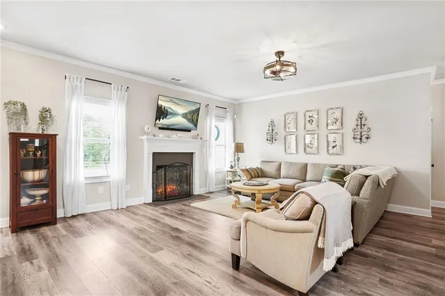 a kitchen with stainless steel appliances kitchen island granite countertop a table chairs and a refrigerator