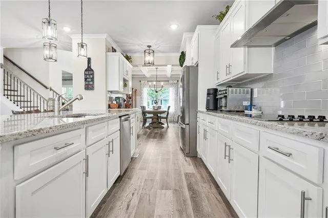 a kitchen with sink cabinets and dining table