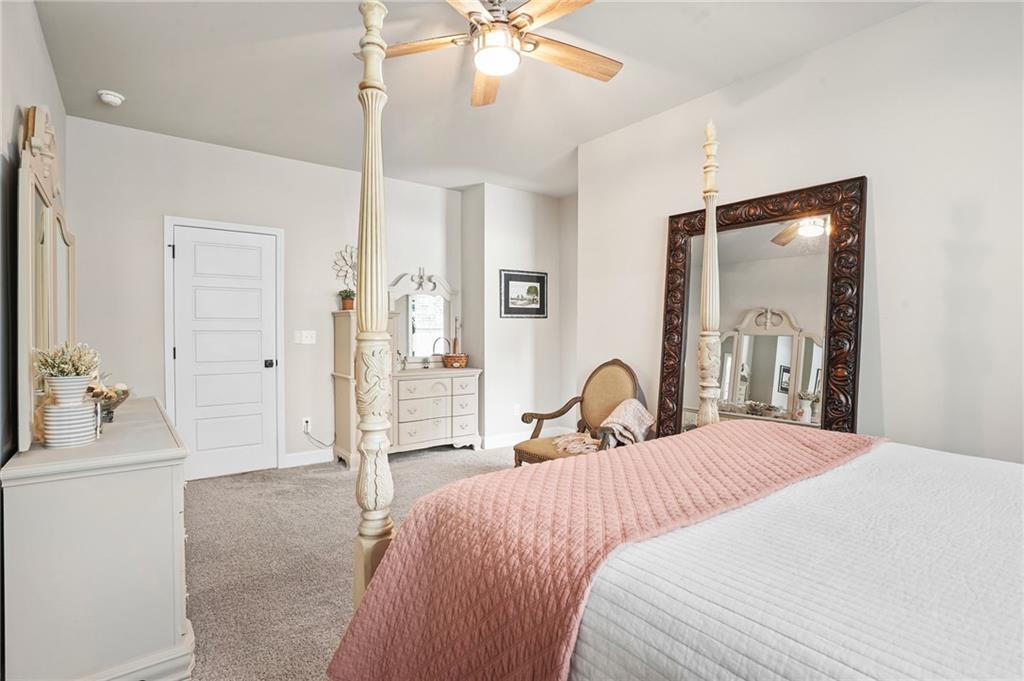 2326 Britt Street Grayson, GA 30017 - Photo 21 of 53 a bedroom with a bed and a chandelier