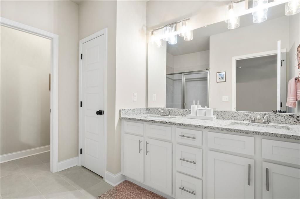 2326 Britt Street Grayson, GA 30017 - Photo 22 of 53 a bathroom with a granite countertop sink and a mirror