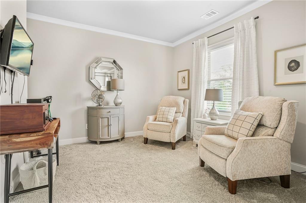 2326 Britt Street Grayson, GA 30017 - Photo 30 of 53 a living room with furniture a flat screen tv and a window