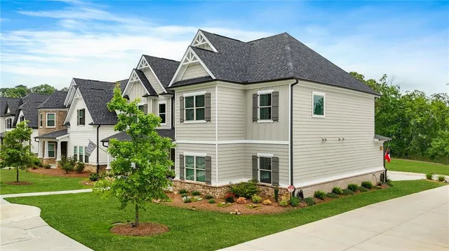 a front view of a house with a yard