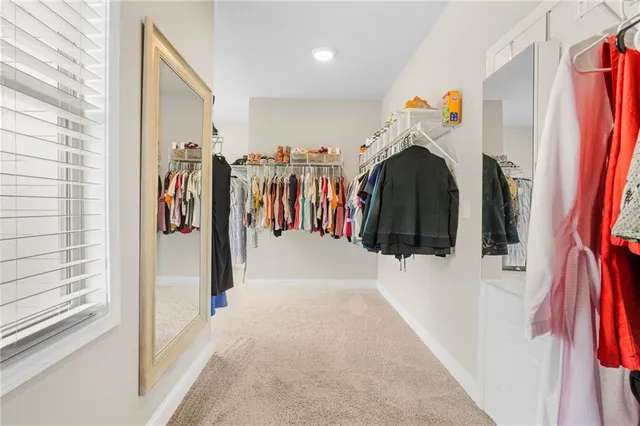 a bathroom with a granite countertop sink mirror vanity and toilet