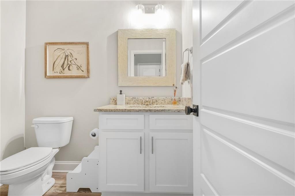 2326 Britt Street Grayson, GA 30017 - Photo 39 of 53 a bathroom with a granite countertop sink mirror vanity and toilet
