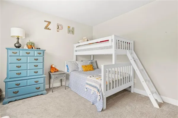 a bed room with a bed and a chair